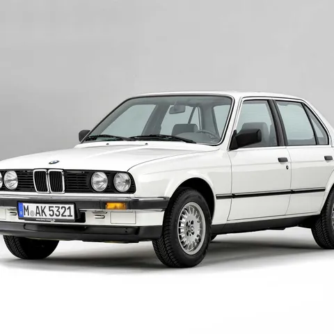 White BMW E30 3 Series four-door saloon, studio front three-quarter shot