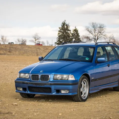 Blue BMW 3 Series E36 Touring wagon parked outdoors