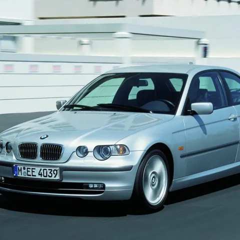 Silver BMW 3 Series E46 Compact hatchback driving on a road