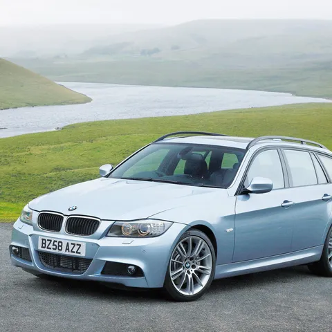 Silver-blue BMW 3 Series E91 Touring wagon parked outdoors near a lake